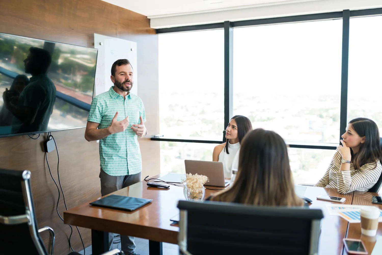 Hispanic-Manager-Sharing-Ideas-With-Team-Meeting-Room-Office (1) Employers Communicate Strategy | Nw Recruiting Partners